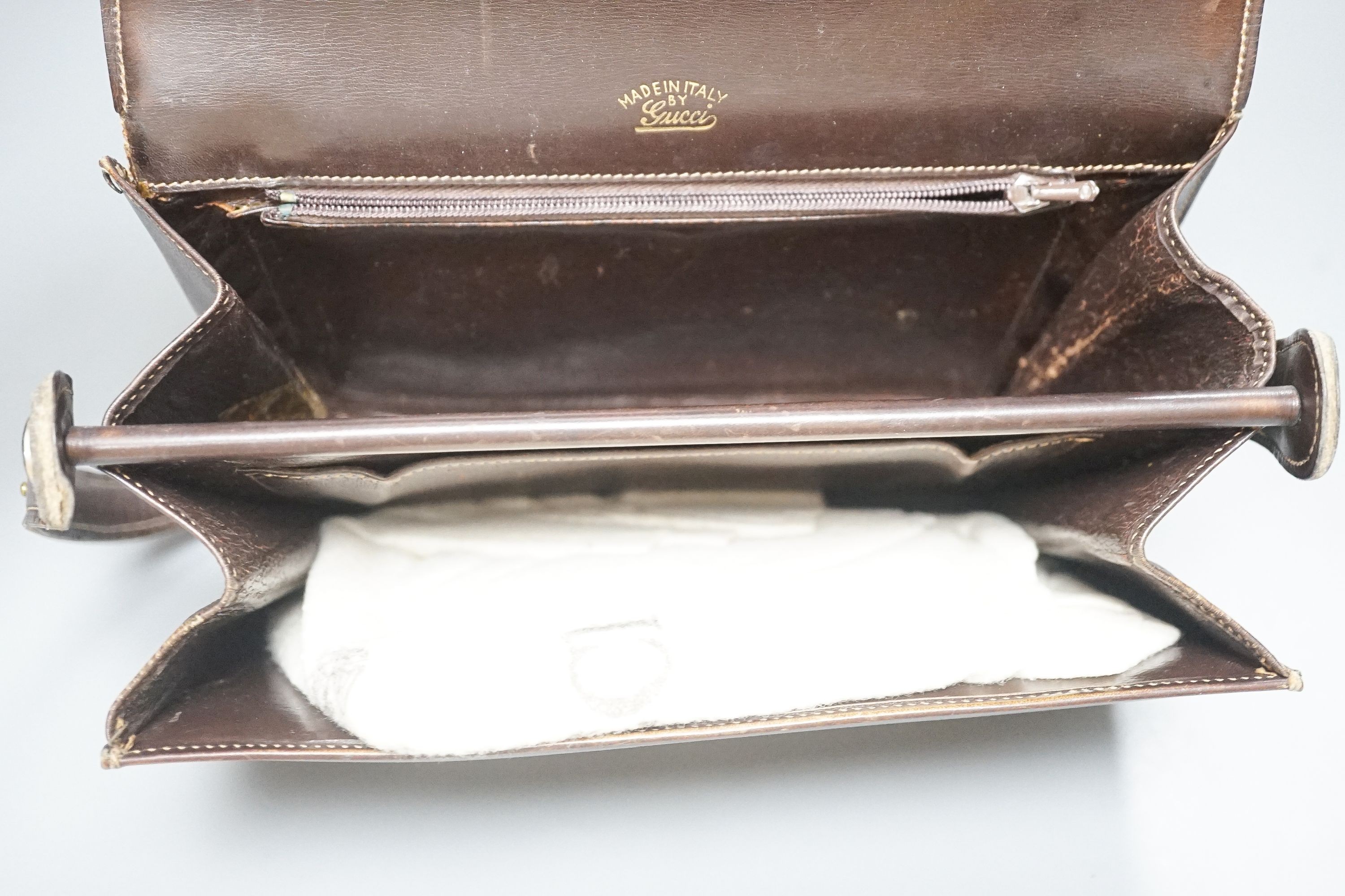 A vintage brown leather handbag stamped 
